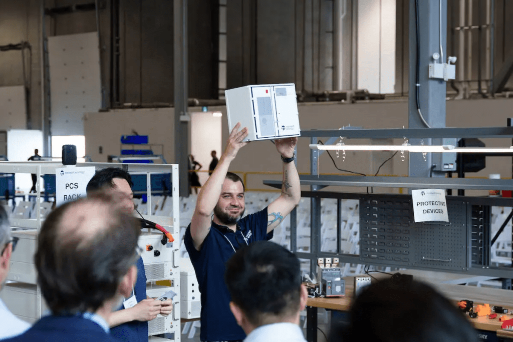 Paddy Riley, lead electrical engineer, holds a small 3D-printed version of the battery energy storage system at Moment Energy factory grand-opening event in Surrey on Tuesday, June 23, 2026, at 12850 112B Ave. (Contributed to Surrey Now-Leader)